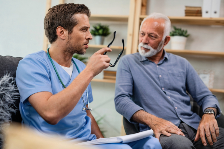 Clinician speaks with older man