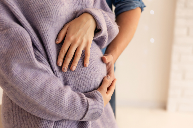 Pregnant women and partner cradle Baby Bump