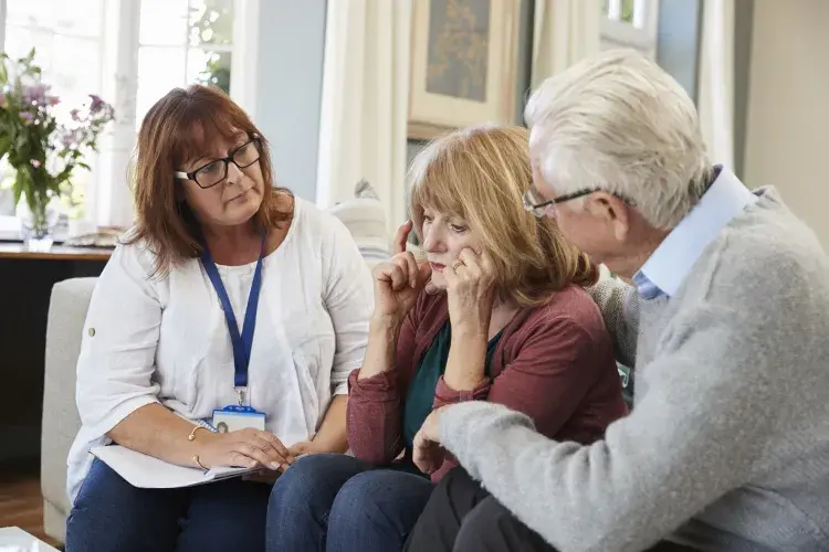 Support Worker Visits Senior Woman Suffering With Depression